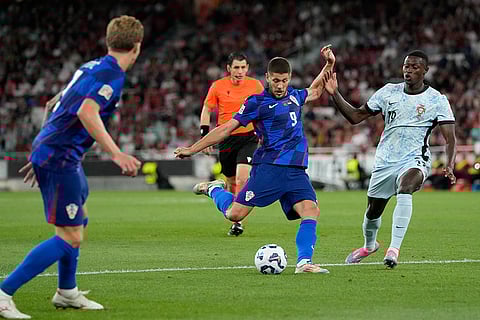 2024-25 Nations League Football Portugal vs Croatia: Croatia's Andrej Kramaric takes a shot as Portugal's Nuno Mendes challenges